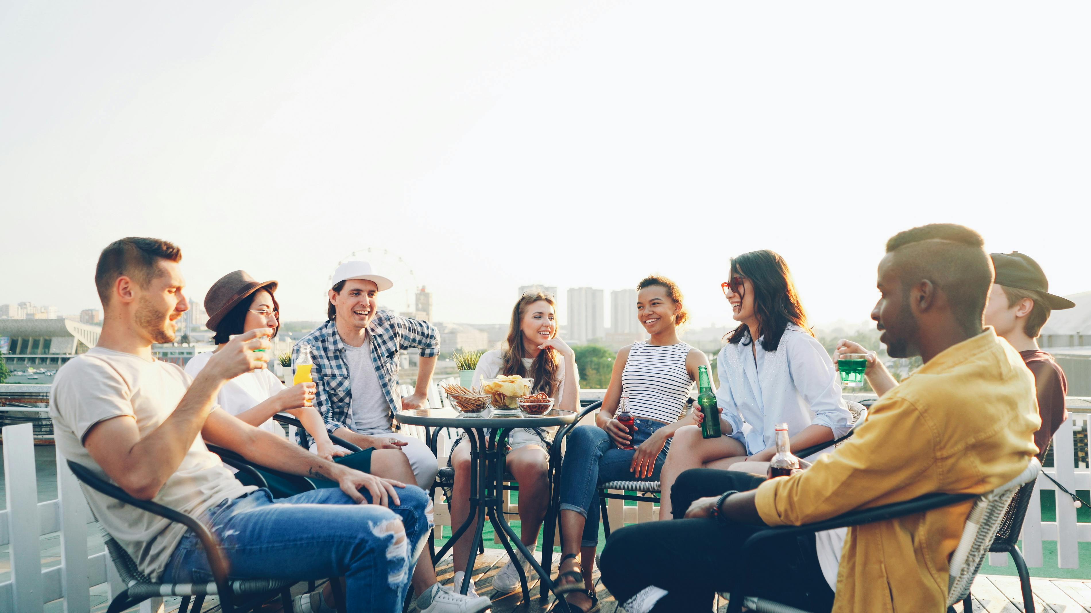 People gathered outdoors drinking stock image