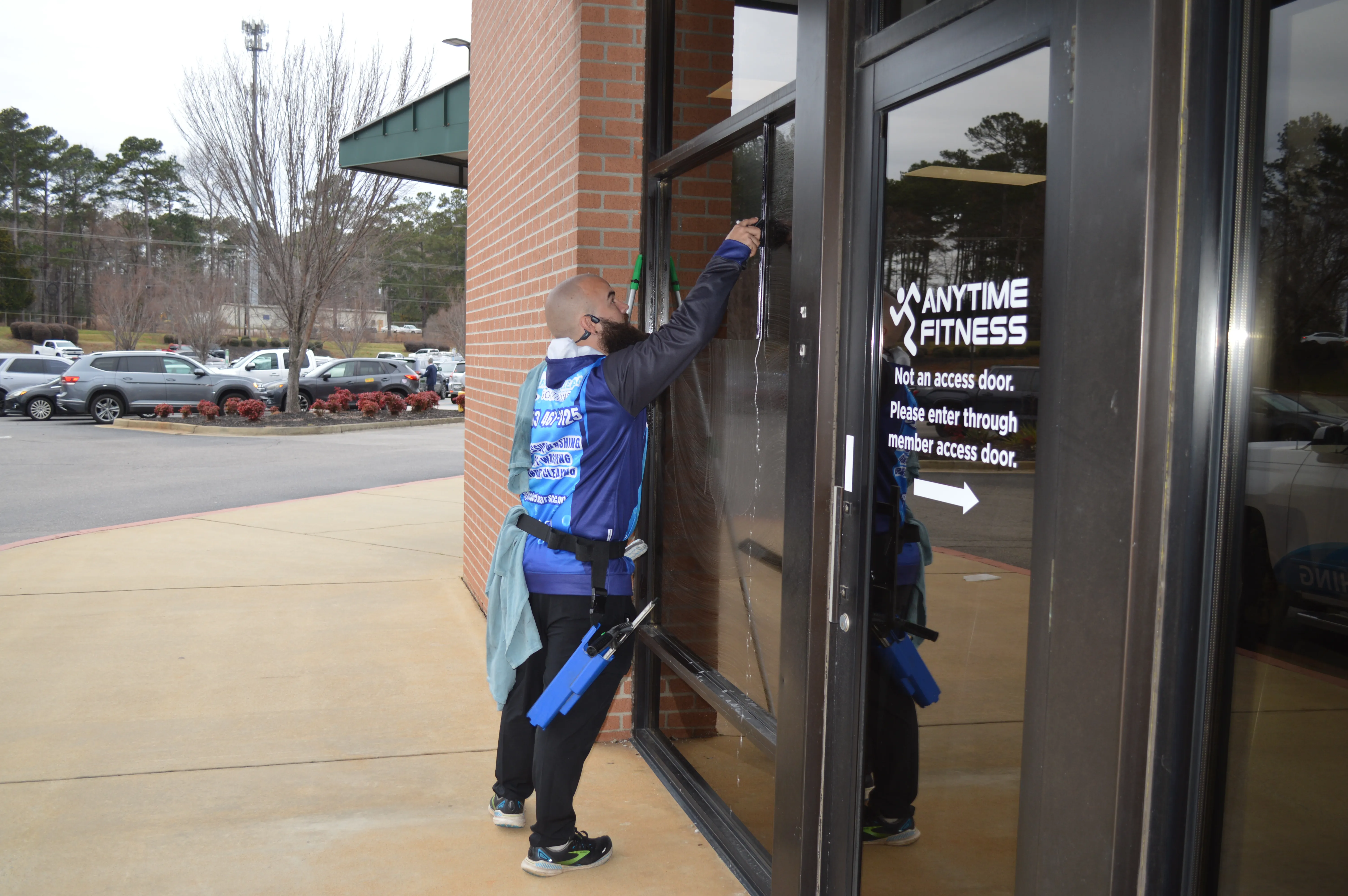 Professional window cleaning service being performed on a residential master bedroom window.