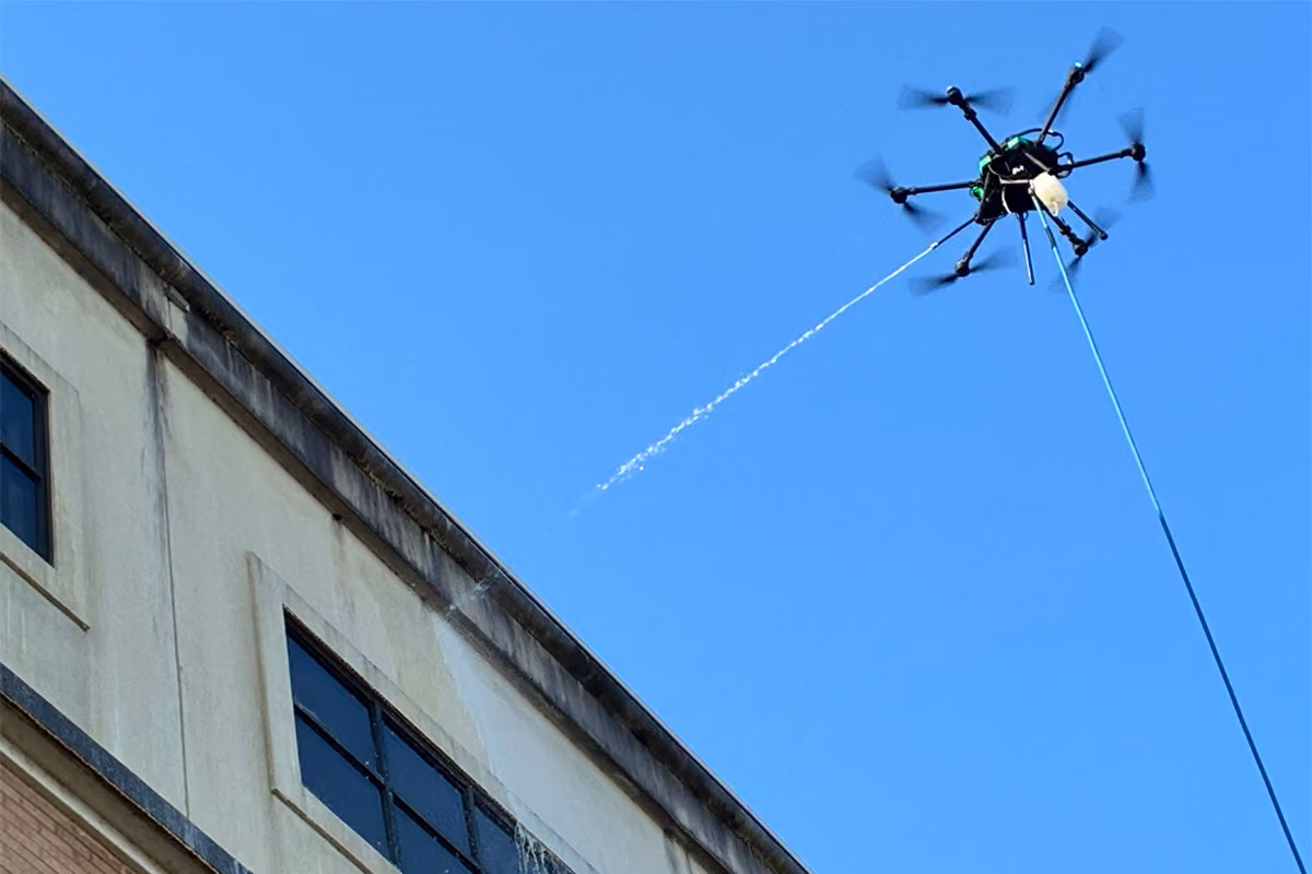 A property facade is being cleaned by one of our power washing drone cleaning systems.