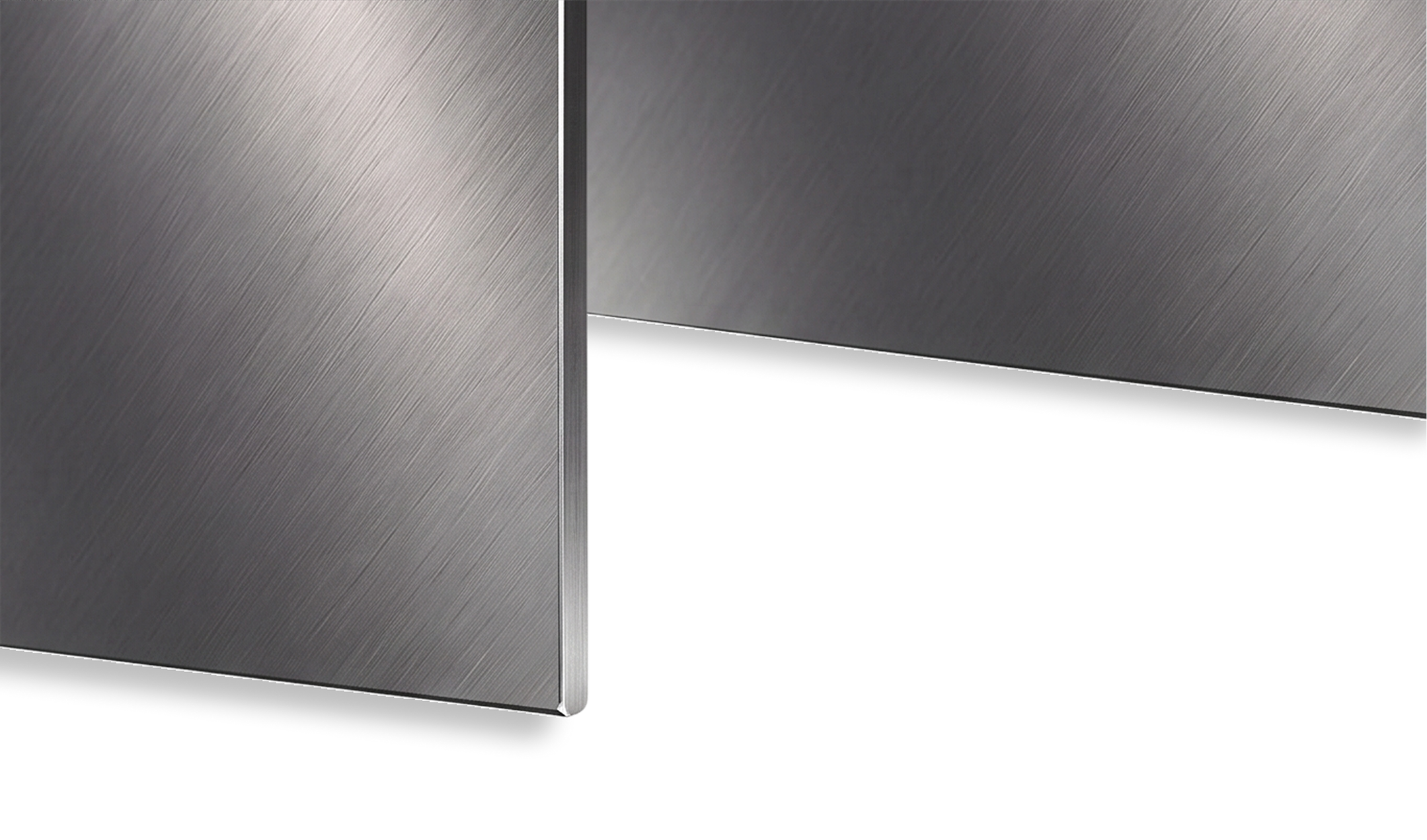 Close-up of two brushed stainless steel panels with diagonal grain texture.