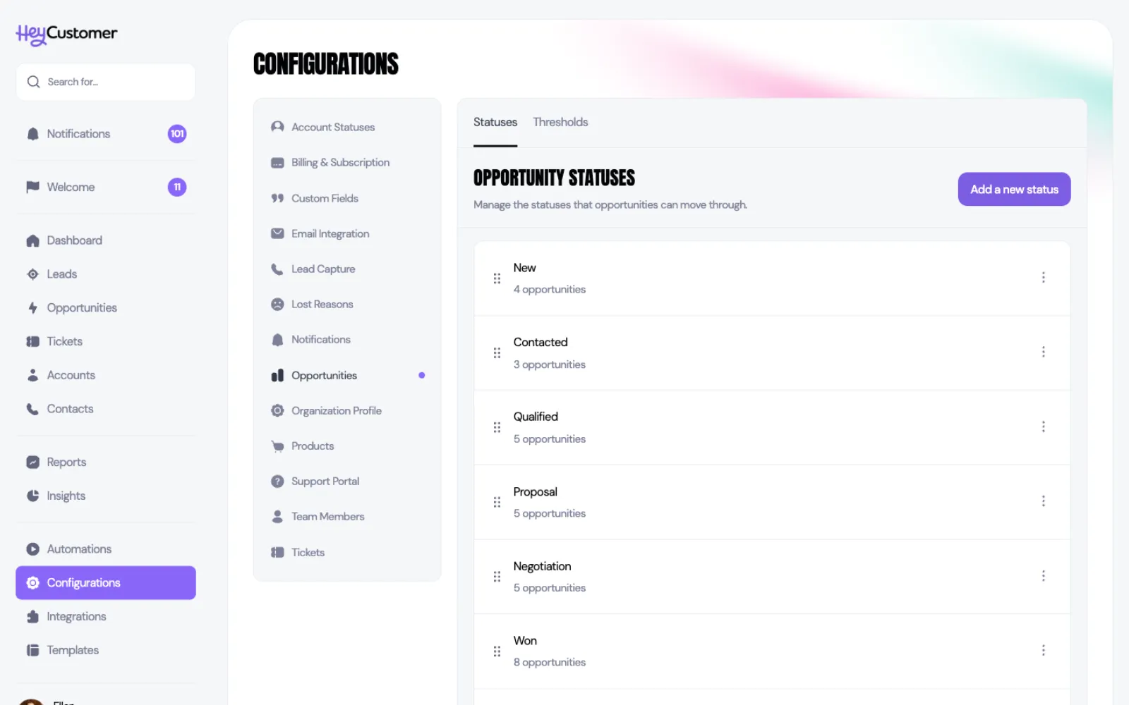 The Opportunity statuses screen under Configurations, listing New, Contacted, Qualified, Proposal, Negotiation and Won in order, each with a drag handle, a count of opportunities in that status and a three-dot menu. An Add a new status button sits top right.