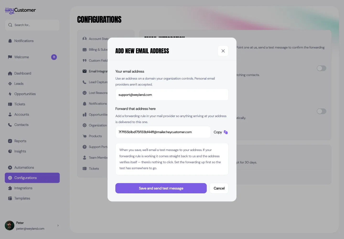 The Add new email address dialog, with support@weyland.com typed into a field labeled Your email address, a forwarding address below it with a Copy button, an explanation that saving sends a test message which verifies the address automatically, and Save and send test message and Cancel buttons.