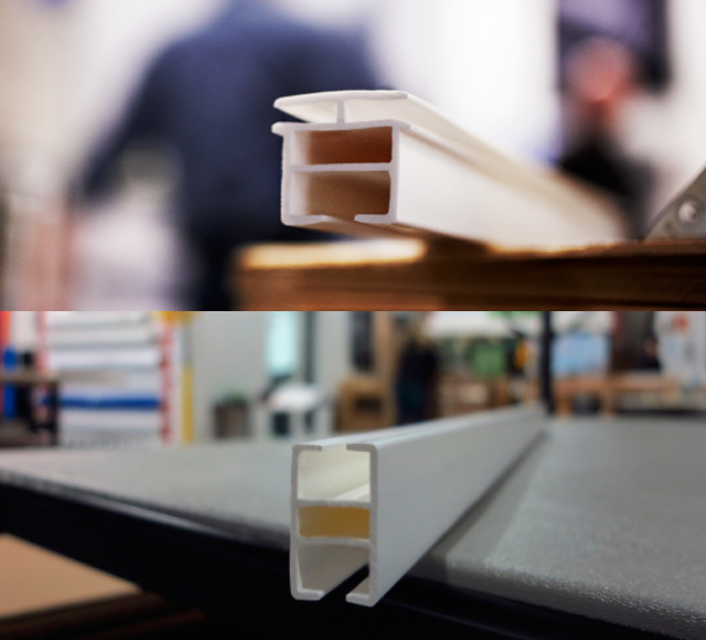 Close-up views of white plastic extrusion profiles placed on surfaces in a workshop environment.