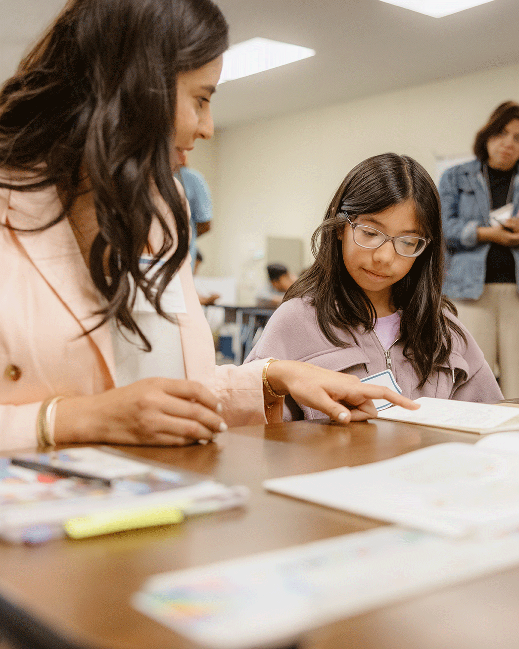 Woman teaching student in classroom.