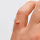 Close-up of a hand making a gesture with the thumb and index finger touching, against a neutral background.