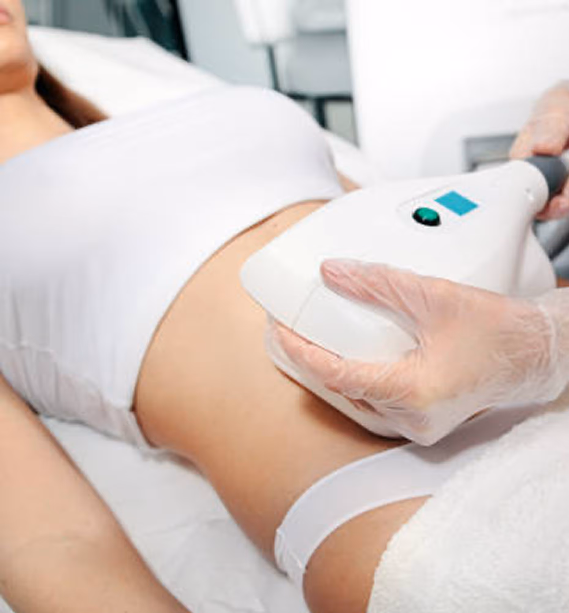 Close-up of a person receiving a body contouring treatment on the abdomen using a handheld device.