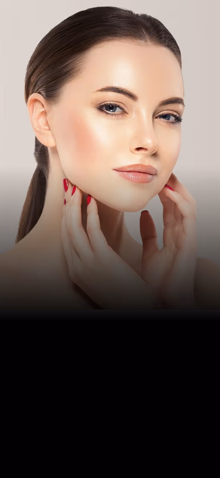 Portrait of a woman with clear skin, red nails, and hair pulled back, touching her neck gently.