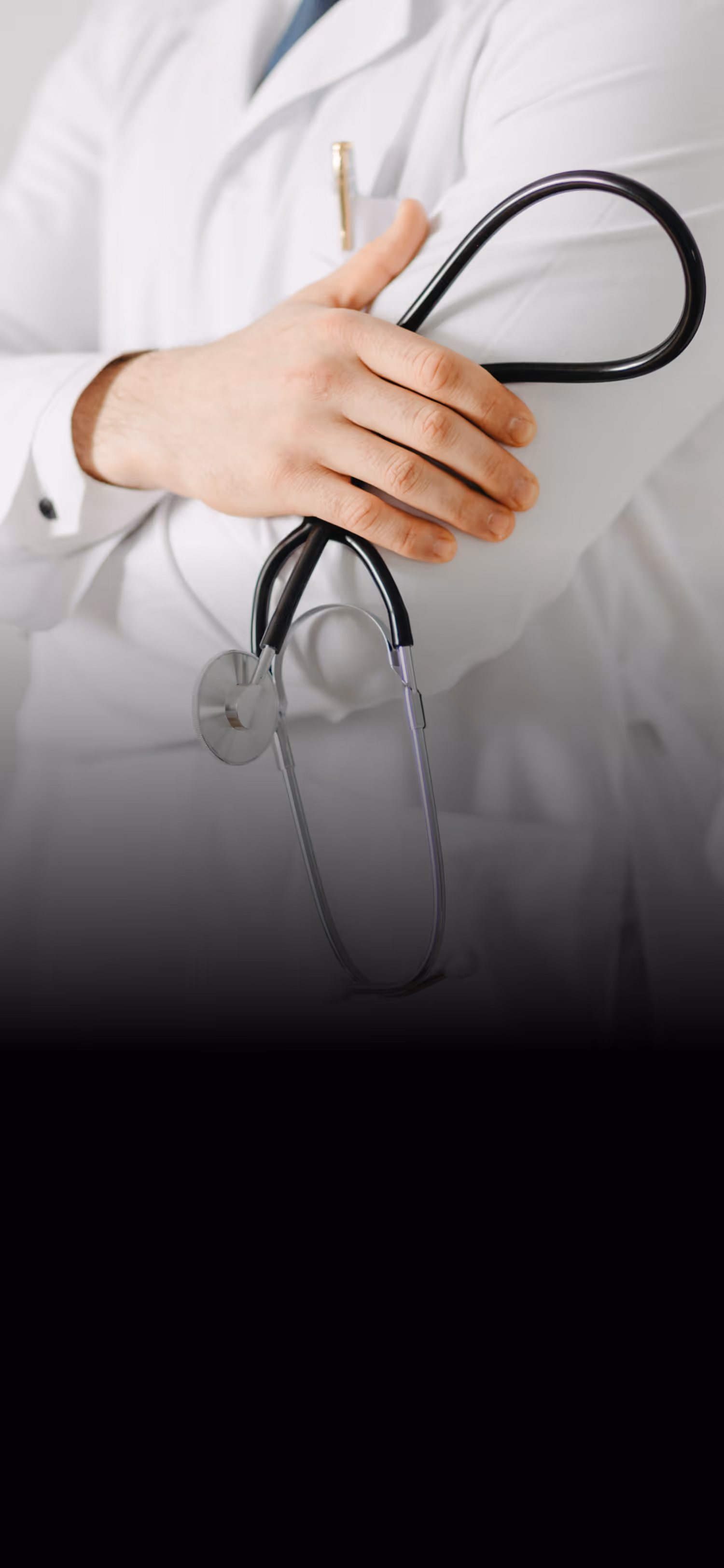 Doctor in white coat holding a black stethoscope crossed over their arm.