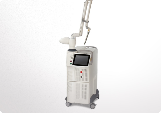 Medical-grade laser machine with a touchscreen and articulated arm on wheels, used for dermatological or cosmetic procedures.