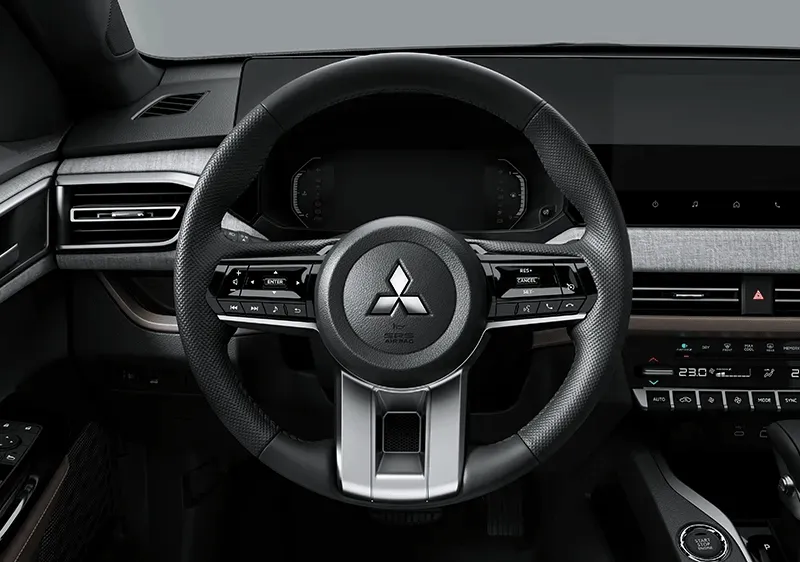 Technician detailing a Mitsubishi vehicle