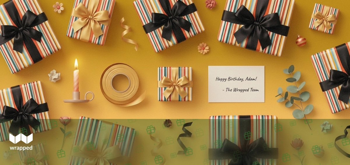Sunlit table with a birthday candle, gold ribbon, a small wrapped box and a handwritten message card
