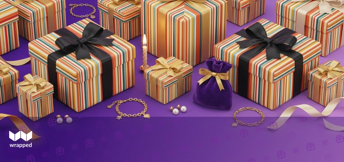 Delicate gold bracelet and pearl earrings arranged beside a birthday candle, velvet pouch and silk ribbon on a soft violet surface
