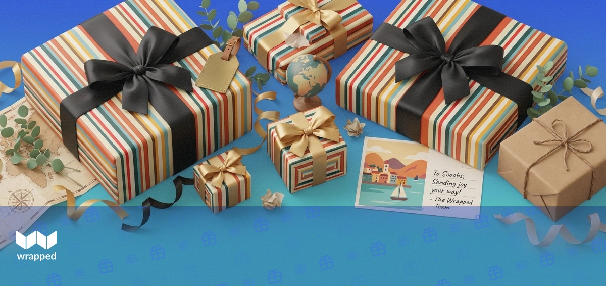 A wrapped parcel, travel postcard, brass luggage tag and small globe arranged on a deep blue editorial surface