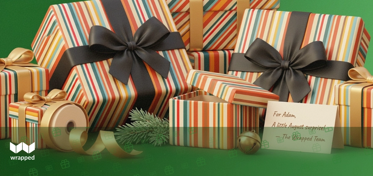 Gold ribbon spool, pine sprig, striped gift box and a handwritten card arranged on a warm green editorial surface
