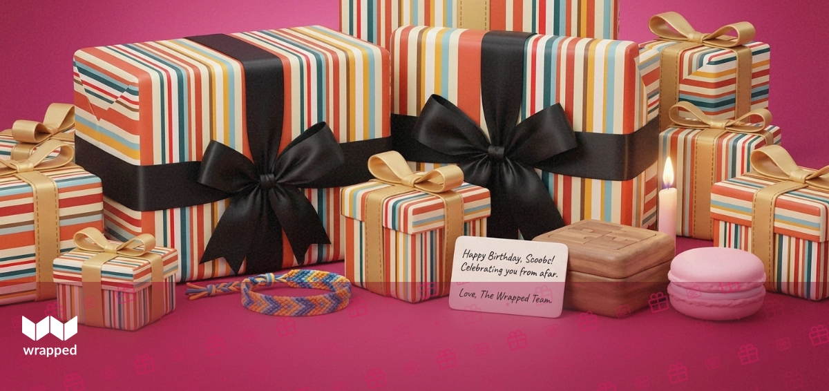 A table set with a birthday candle, friendship bracelet, macaron and a handwritten card in soft rose light