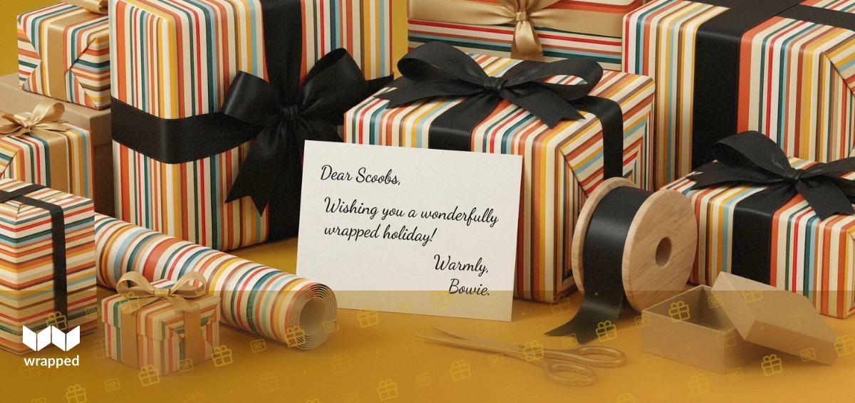 Striped gift wrap, satin ribbon, a handwritten message card and a small kraft box arranged on a bright table
