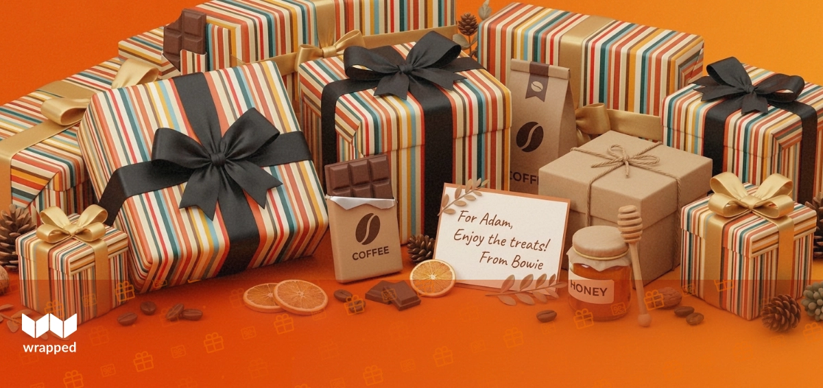 A twine-tied gift box with chocolate, coffee and a honey jar beside a handwritten message card on a warm amber table