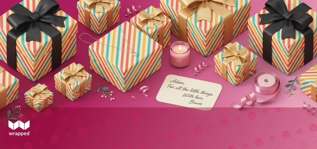 Editorial still life with a silver necklace, handwritten message card, small pink candle and satin ribbon on a rose backdrop