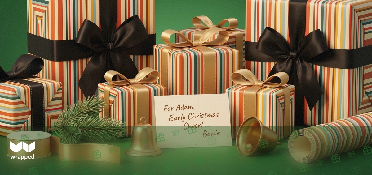 Autumn desk scene with pine sprig, gold ribbon, patterned wrapping paper and a handwritten gift card in warm light