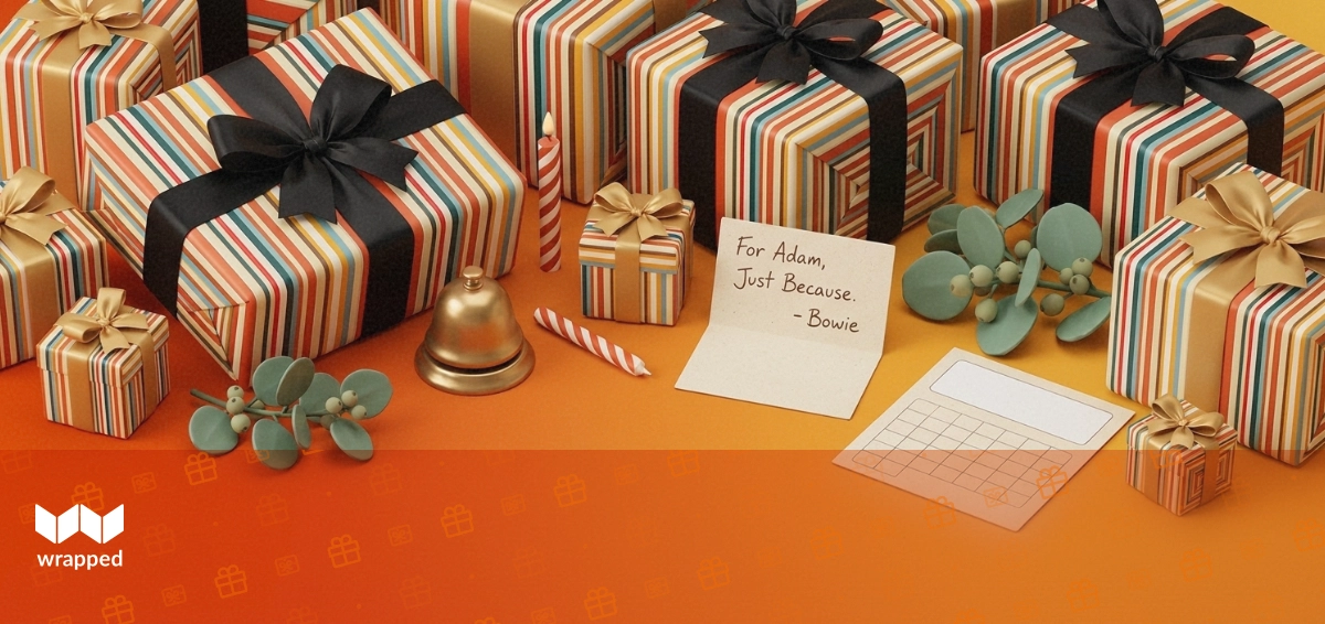 Amber-lit desk with a birthday candle, small ribboned gift box, handwritten message card and a sprig of eucalyptus