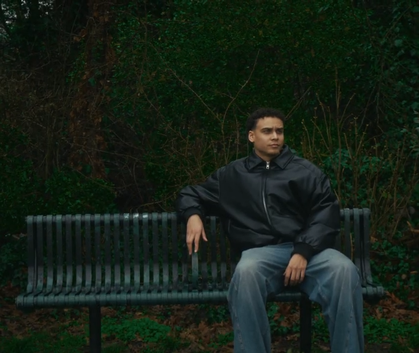 A photographer sitting on a bench.