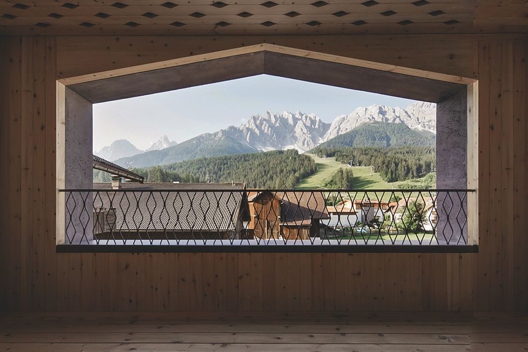 A suite at ATTO in Innichen, the loggia framing the Haunold and the Dolomites