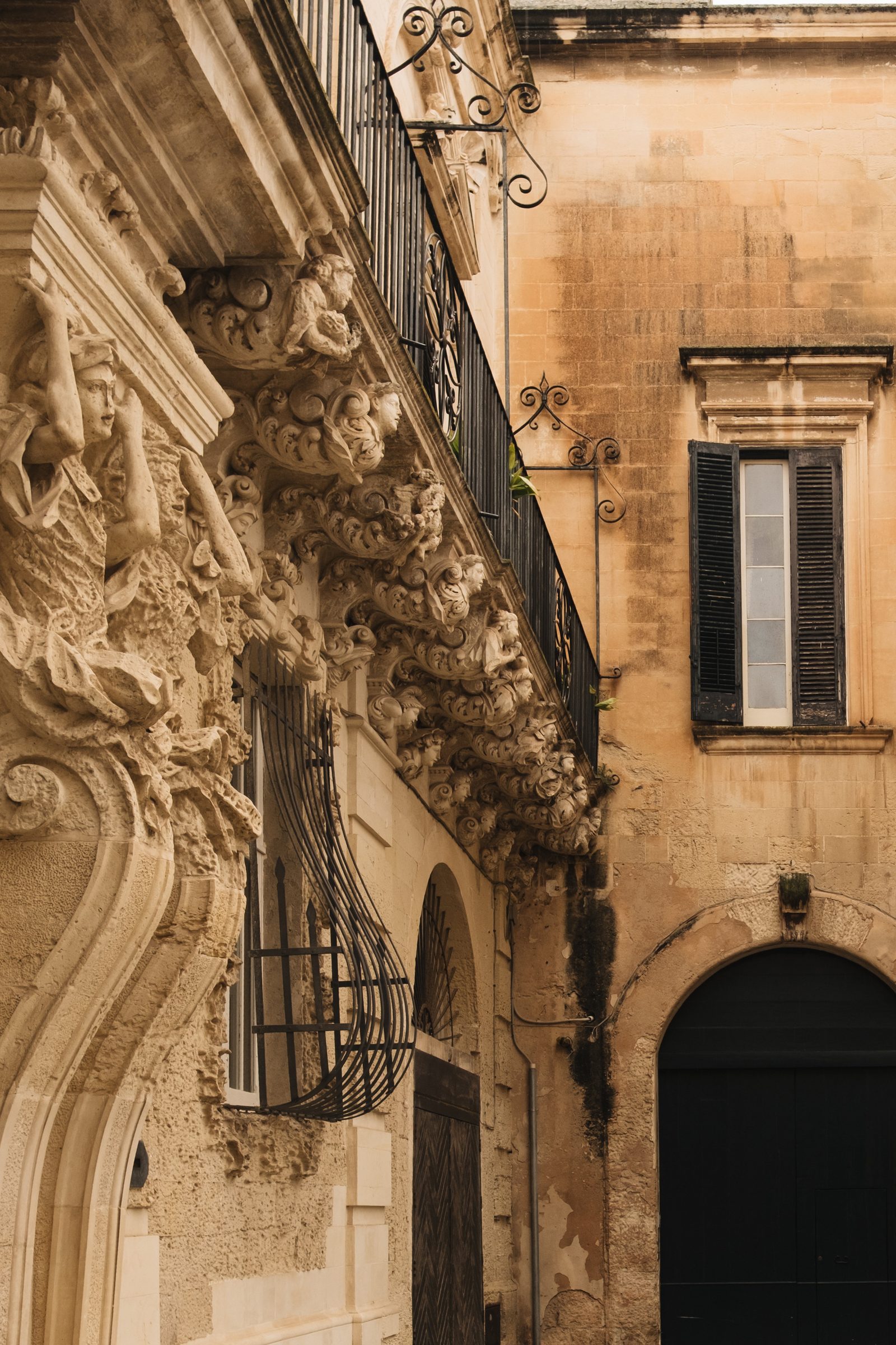 Baroque balcony brackets carved with faces and scrolls in Lecce's old town