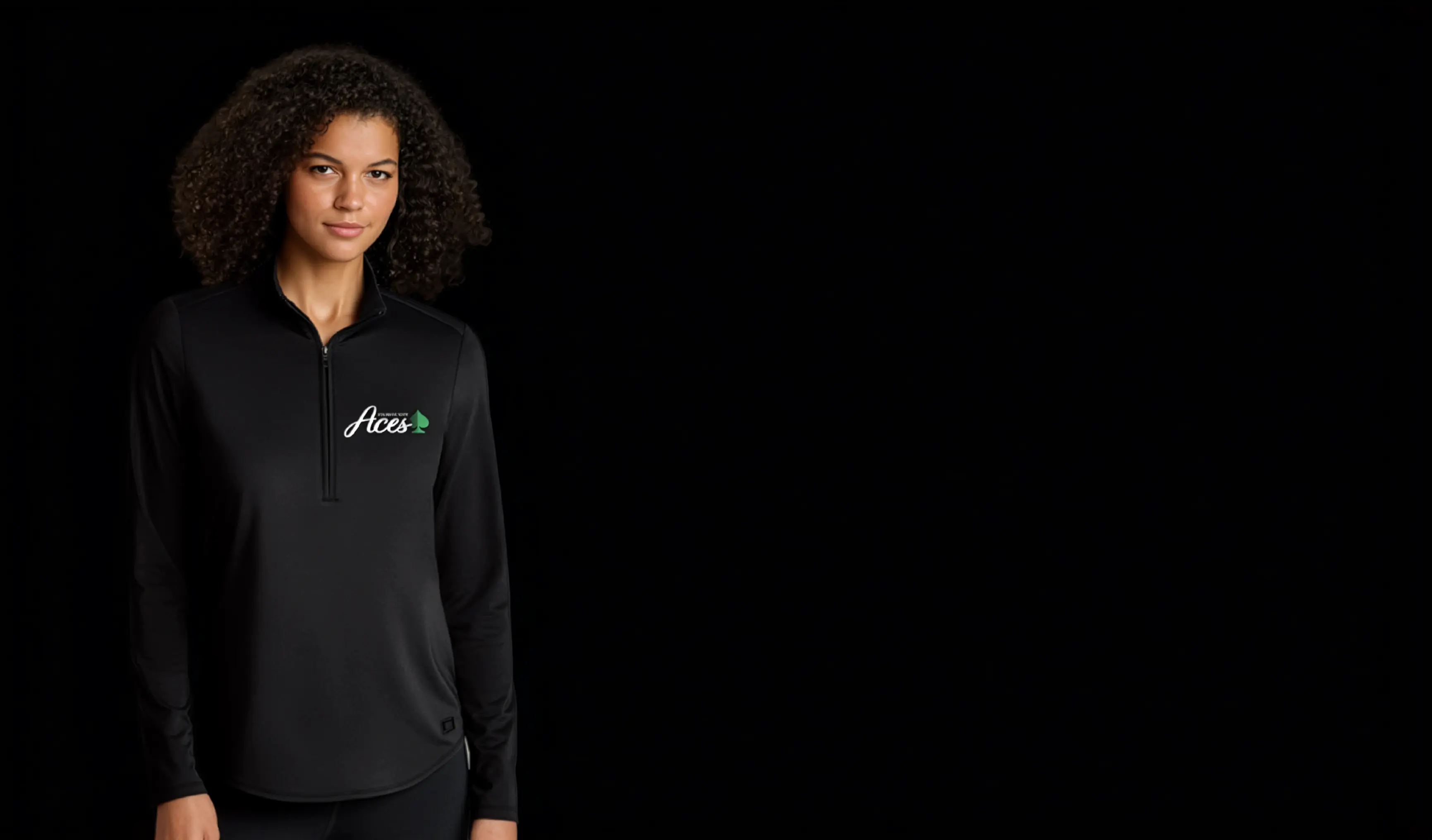 A woman with dark curly hair wears an Atlantic City Aces sweatshirt