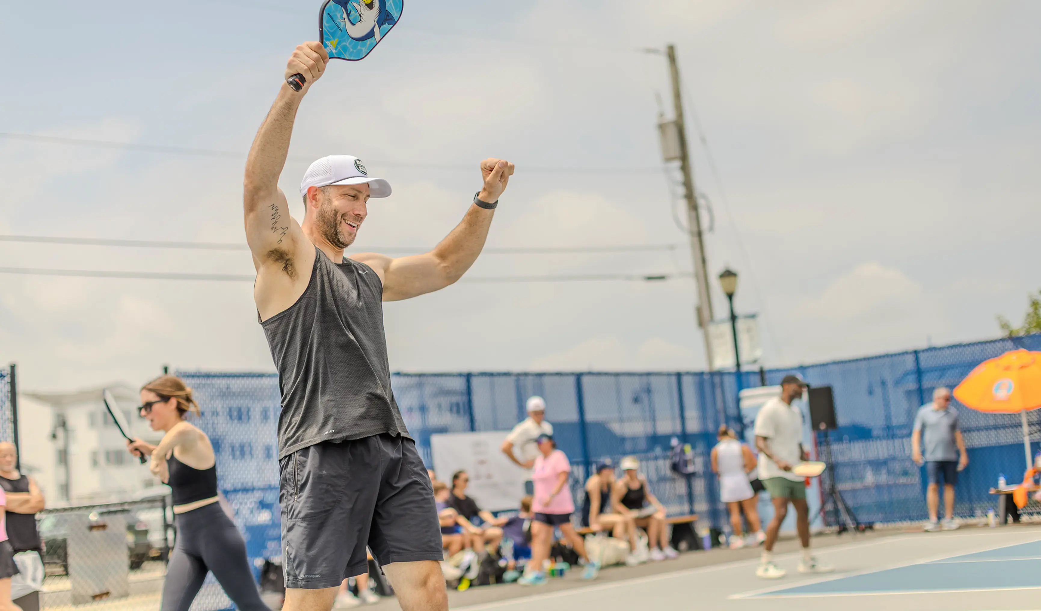 A male pickleball player celebrates after winning a point
