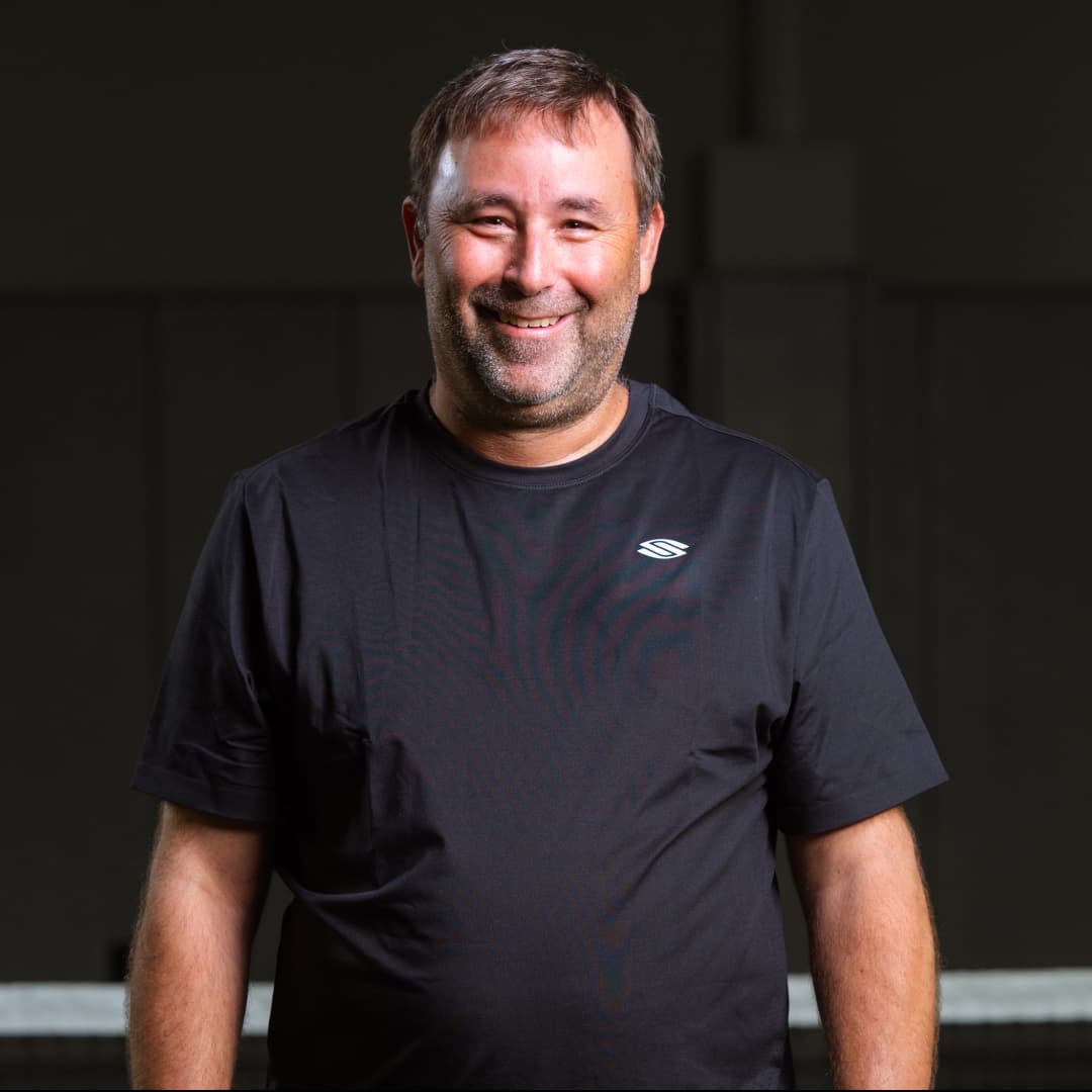 Profile picture of Ben Wenger wearing a black t-shirt with stylized 's'. 