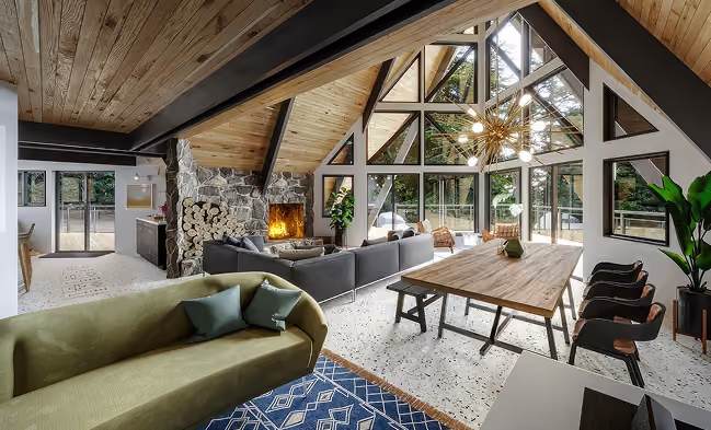 Bright, modern living space with wood accents, large windows, and cozy furniture.
