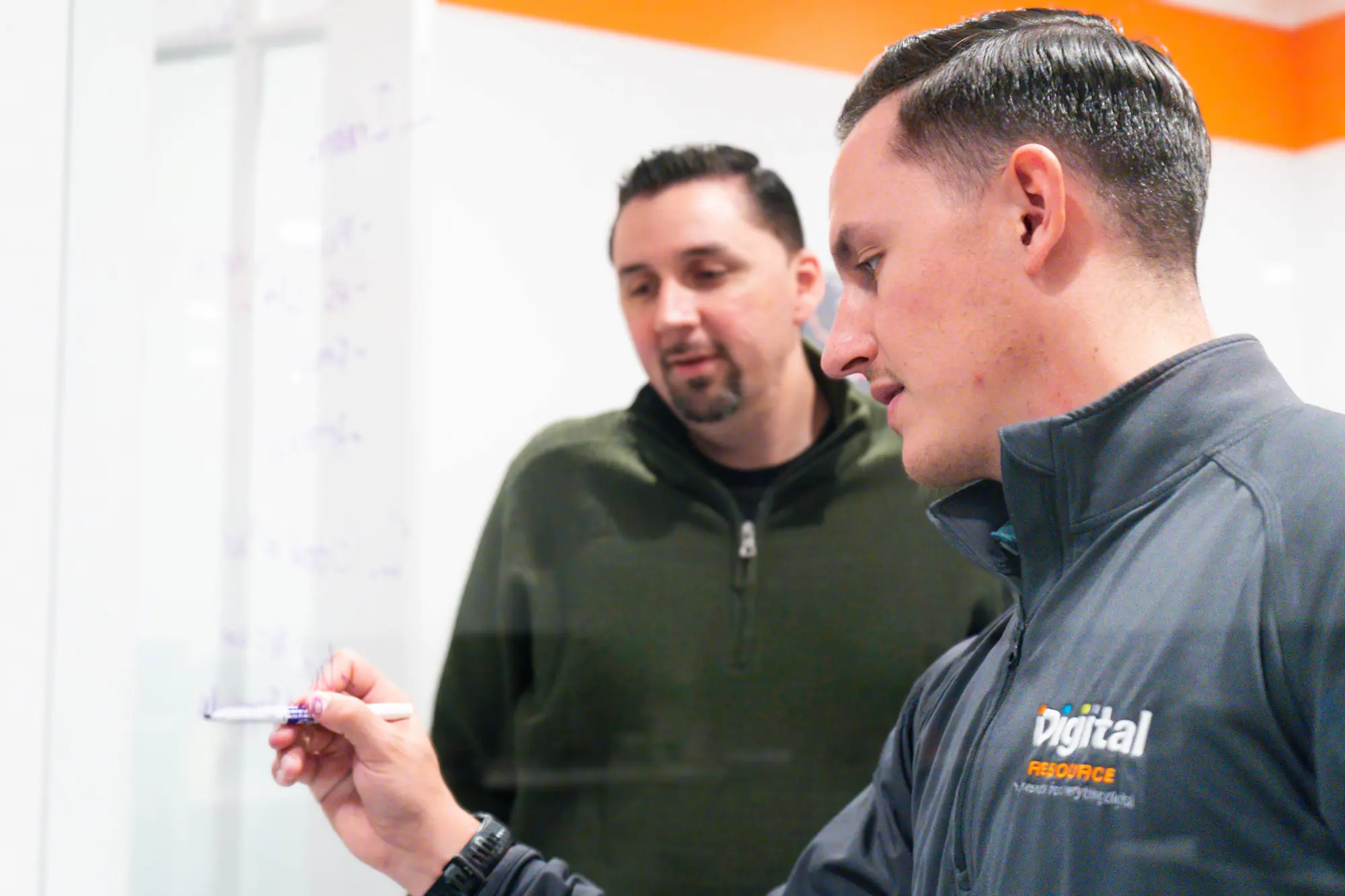 Two men in work uniforms having a conversation
