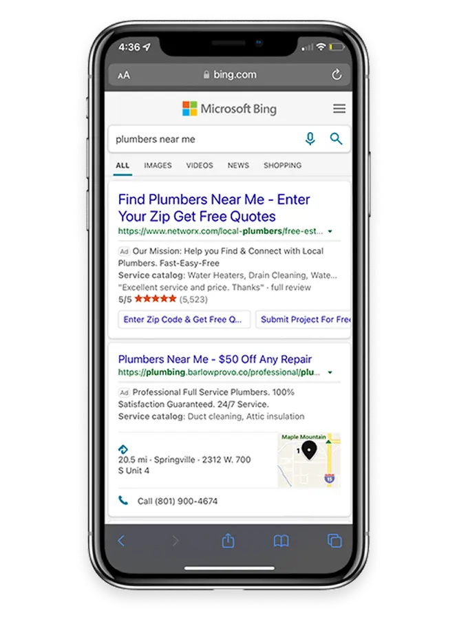 Smartphone screen showing a Bing search results page for 'plumbers near me' with two ads listing local plumbing services, contact info, ratings, and a small map snippet.