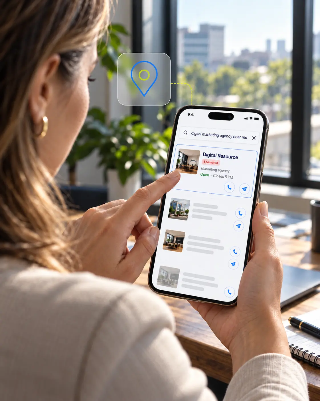 A woman holding a smartphone and using a local search app to find a digital marketing agency near her, selecting a sponsored listing named Digital Resource, with an open status and closing time of 5 PM, shown on the screen.