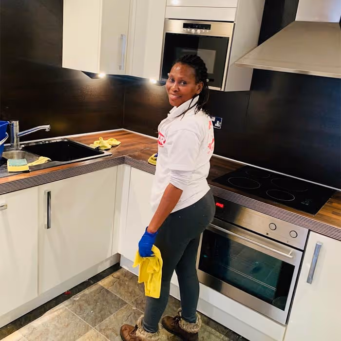 ACR Cleaning Ltd technician is providing professional domestic cleaning in a kitchen.