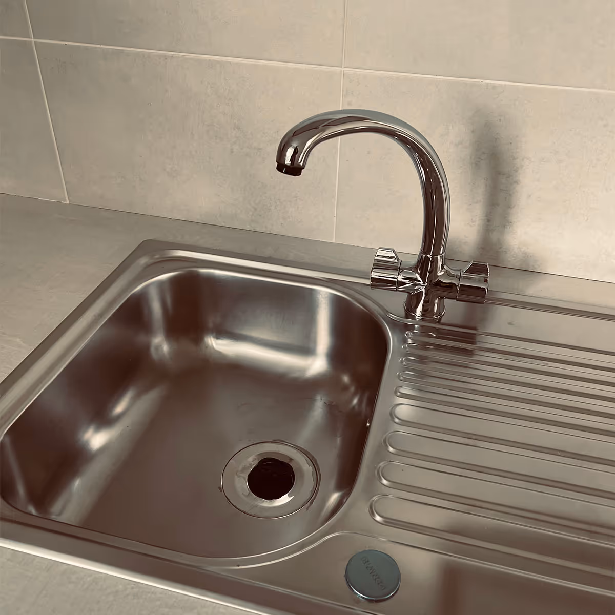 A kitchen sink that is immaculate after professional cleaning services in Cambridge by ACR Cleaning Ltd.