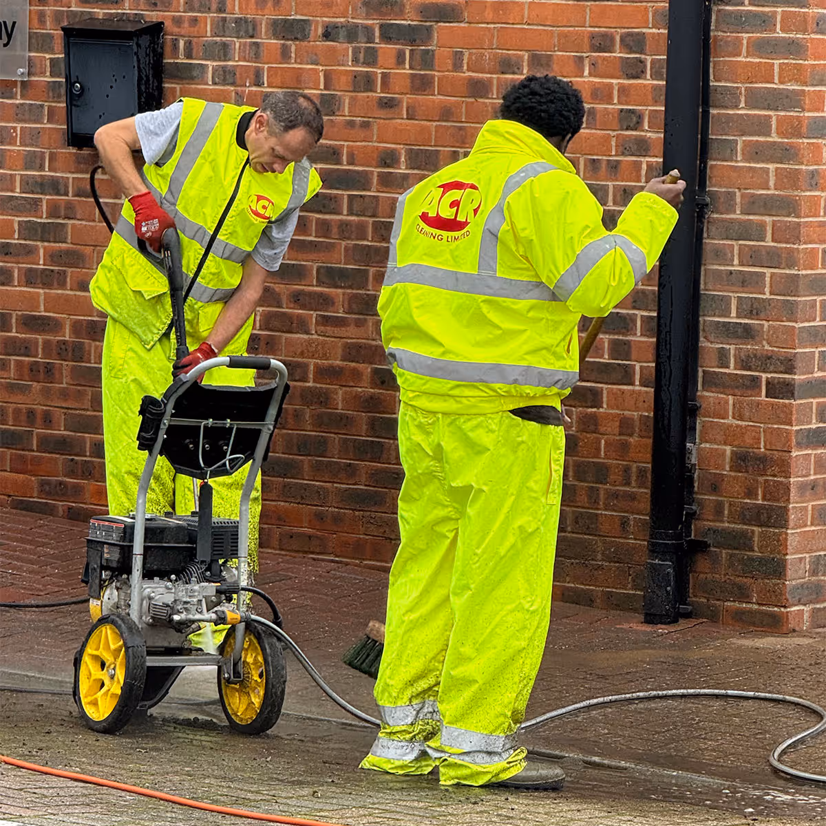 Two ACR Cleaning Ltd technicians providing residential pressure washing.