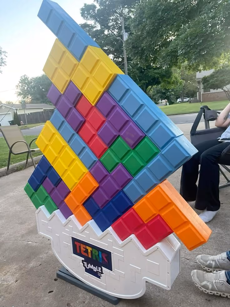 Giant Tetris Tumble yard game with colorful interlocking blocks stacked on a rocking base