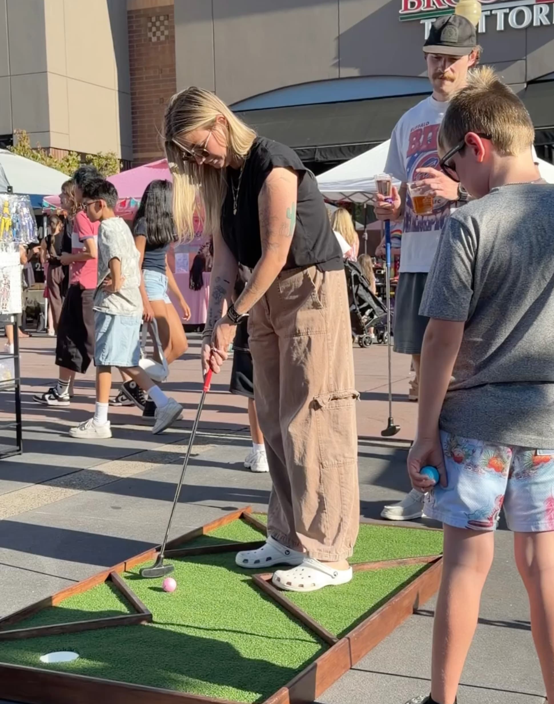 Families playing mobile mini golf during the Bethany Village concert series