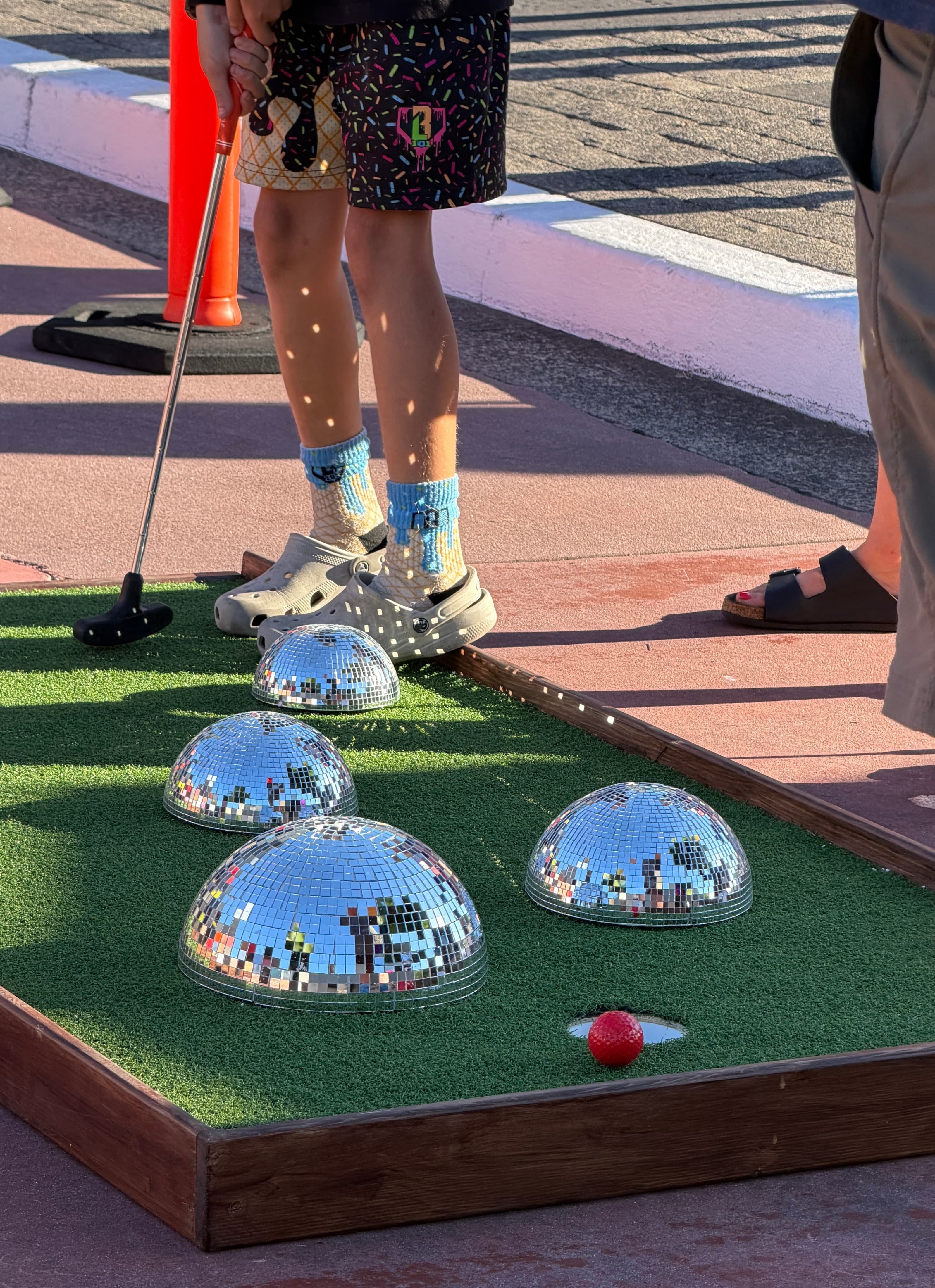 Families playing mobile mini golf during the Bethany Village concert series