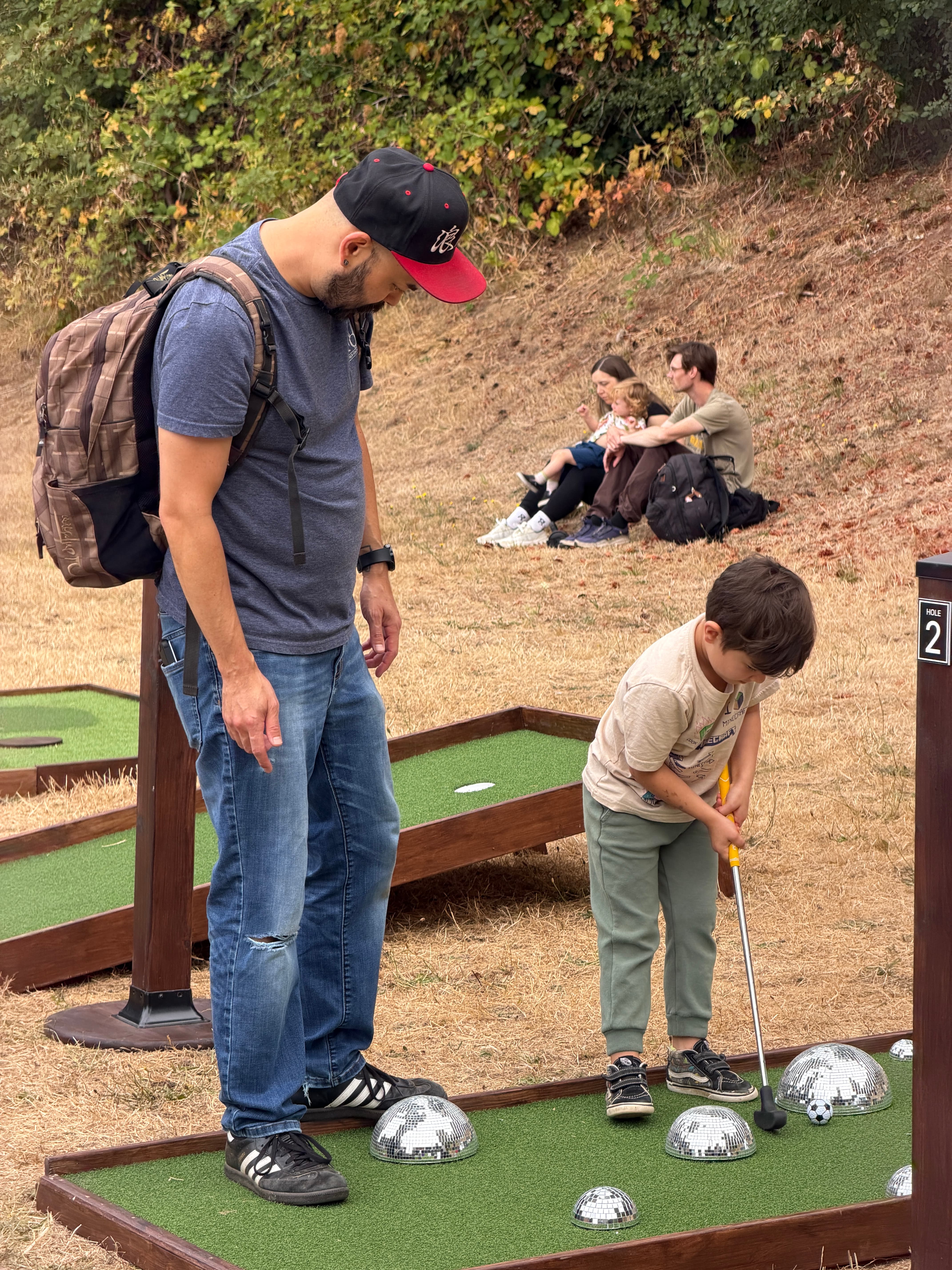 Spectators playing mobile mini golf at the PDX Adult Soapbox Derby