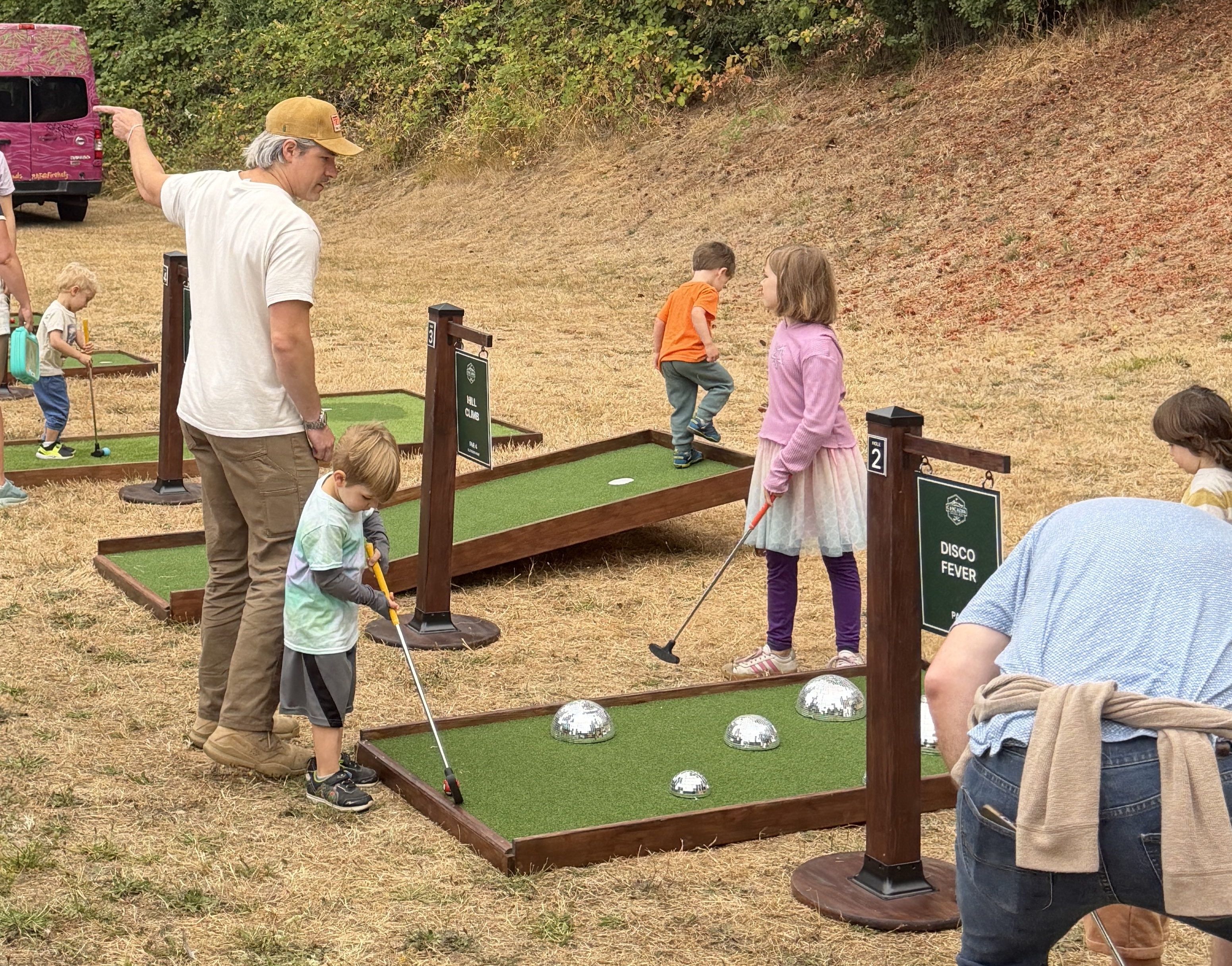 Spectators playing mobile mini golf at the PDX Adult Soapbox Derby