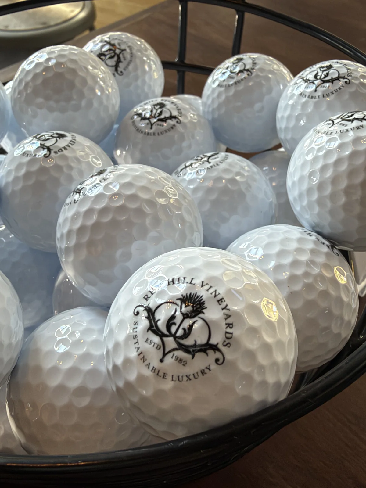 Custom REX HILL golf balls in a bowl for the winery's mini golf event