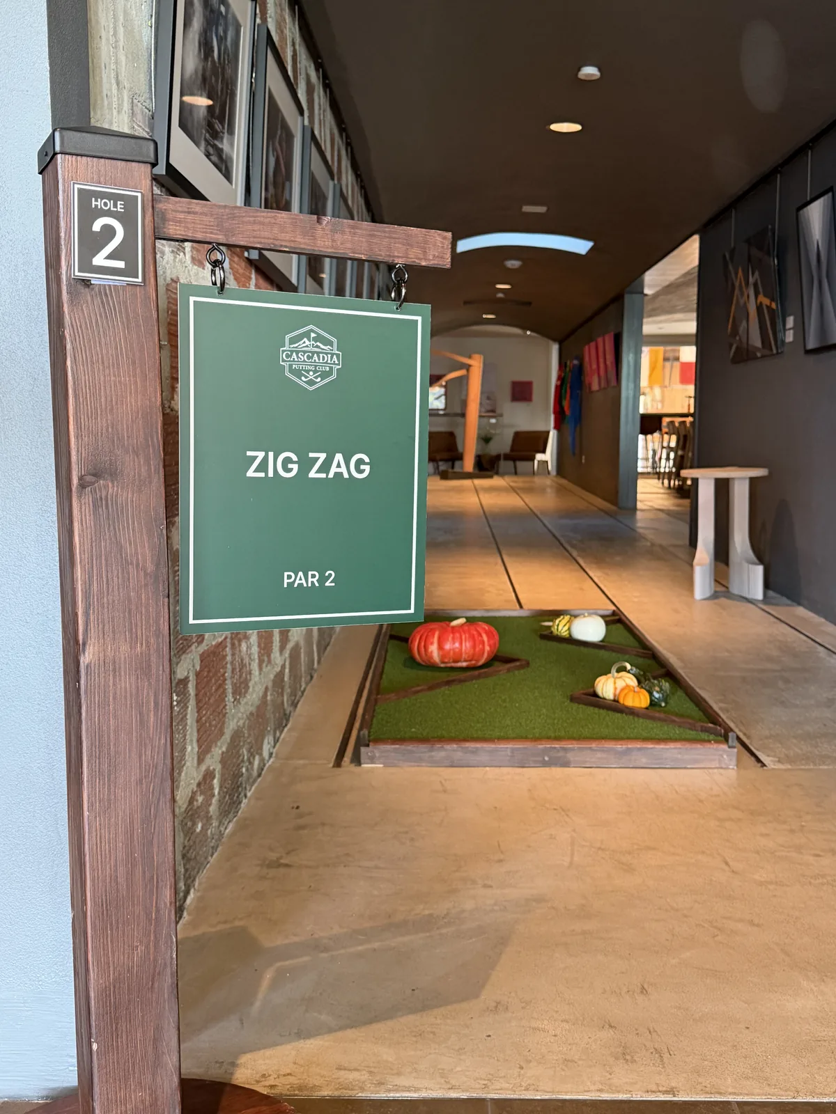 Zig Zag mini golf hole sign inside the REX HILL tasting room