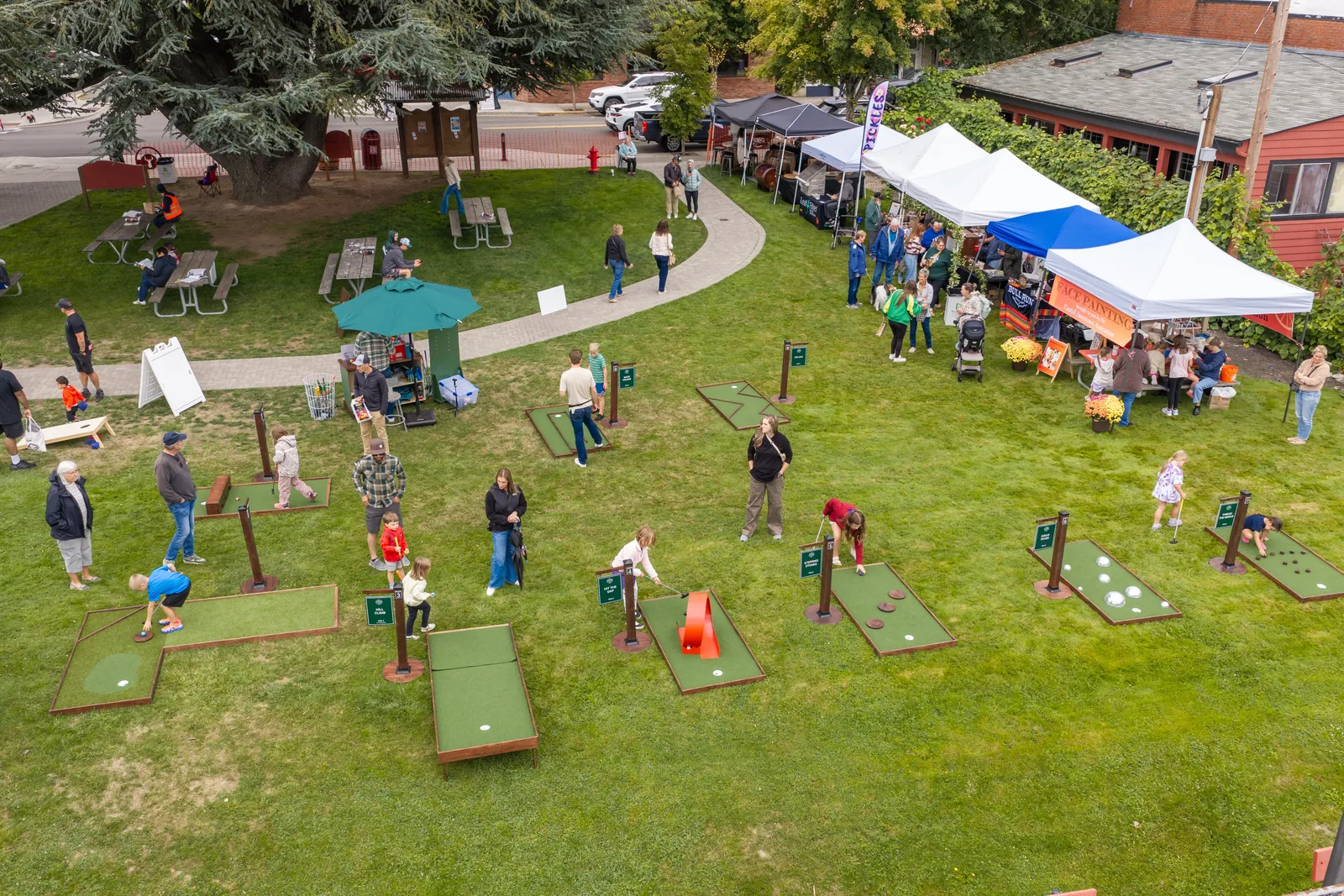 Overhead view of families playing mini golf on the lawn at Carlton Crush Harvest Festival