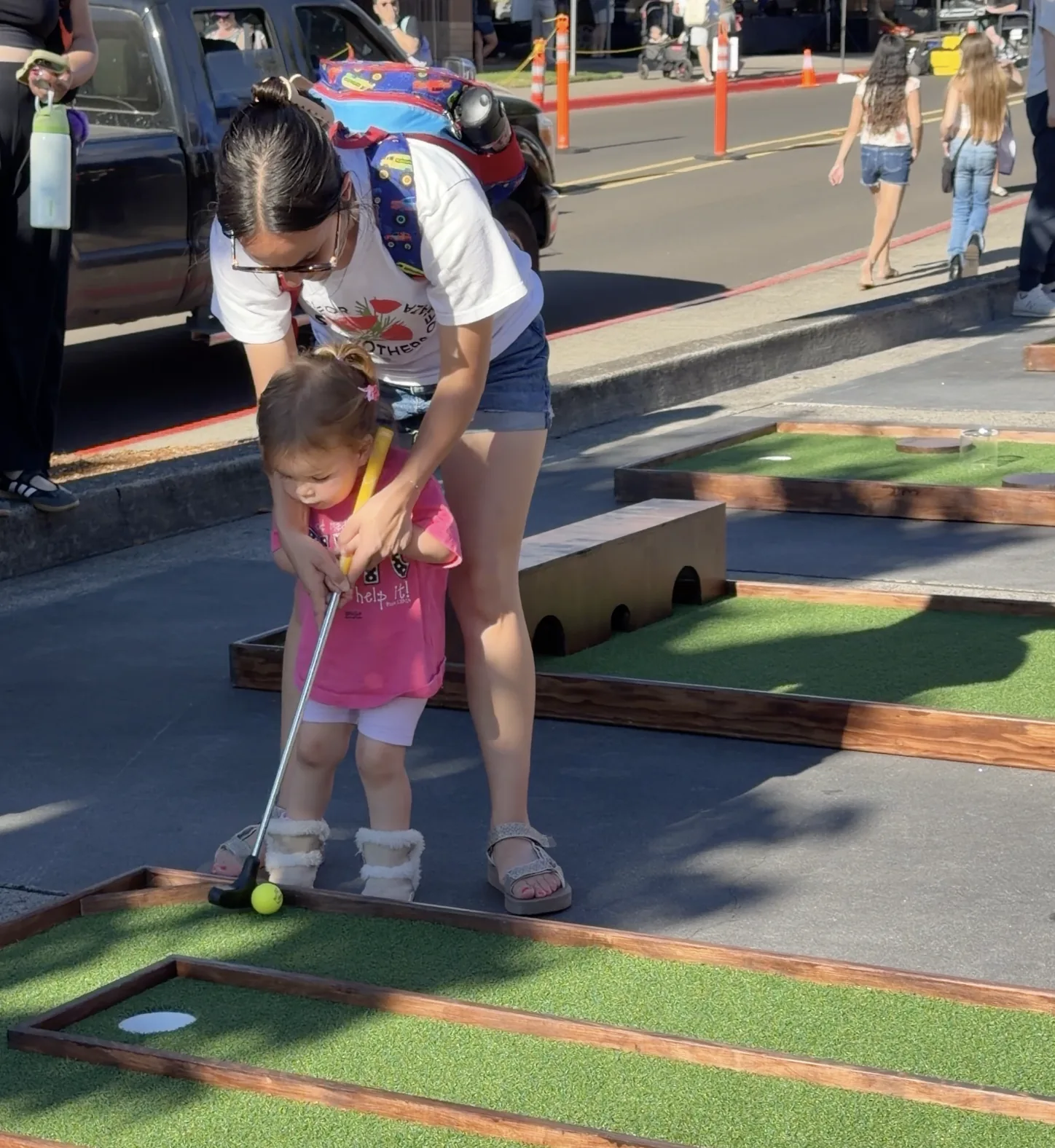 Families playing mobile mini golf during the Bethany Village concert series