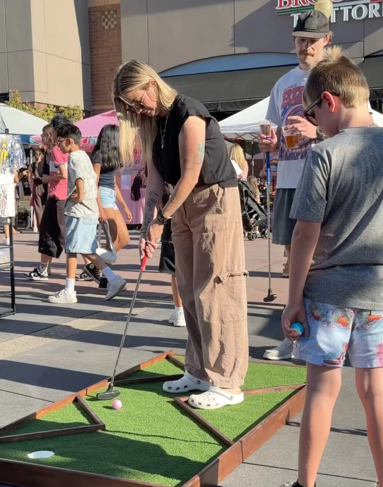 Families playing mobile mini golf during the Bethany Village concert series