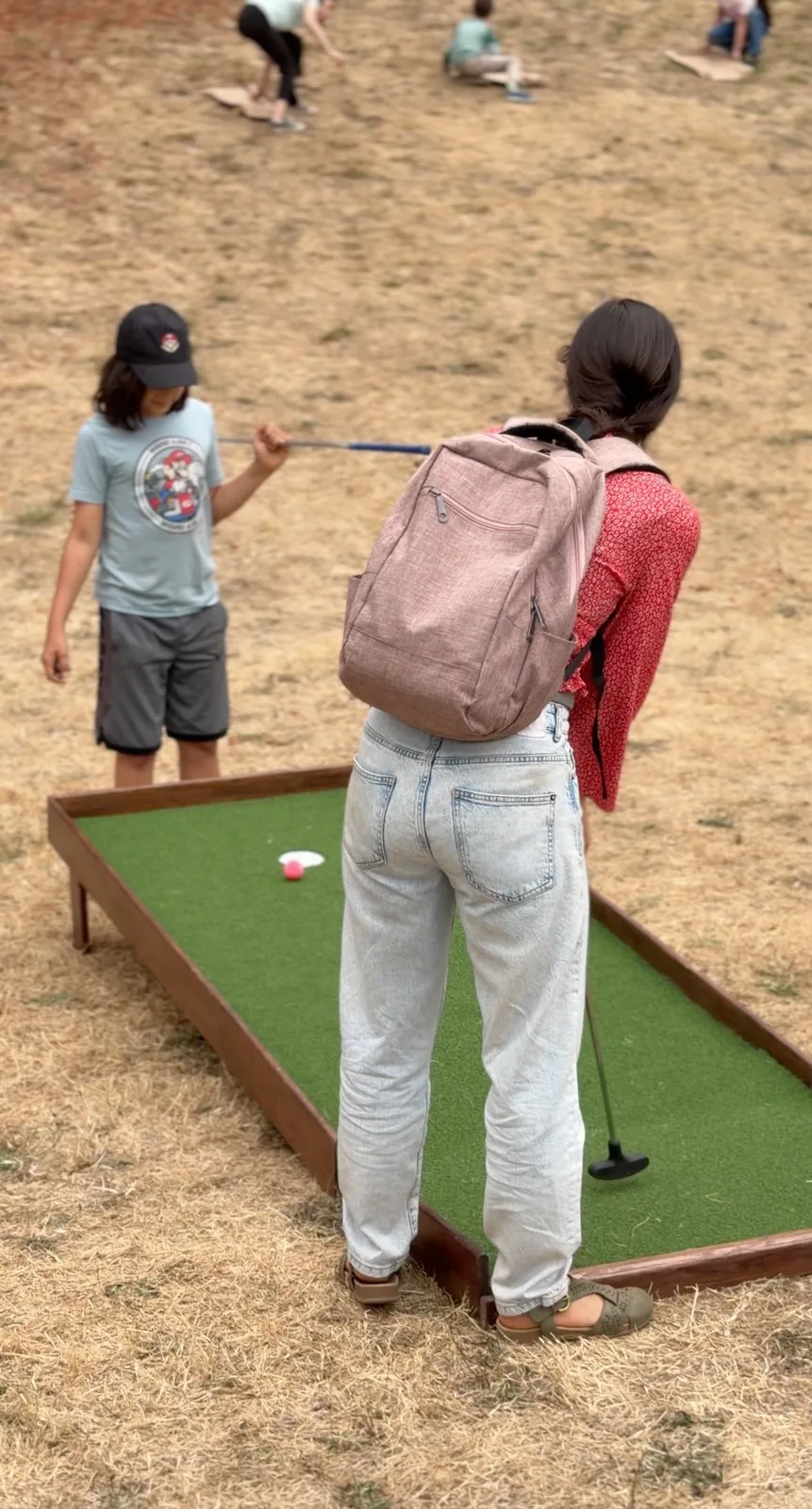 Spectators playing mobile mini golf at the PDX Adult Soapbox Derby