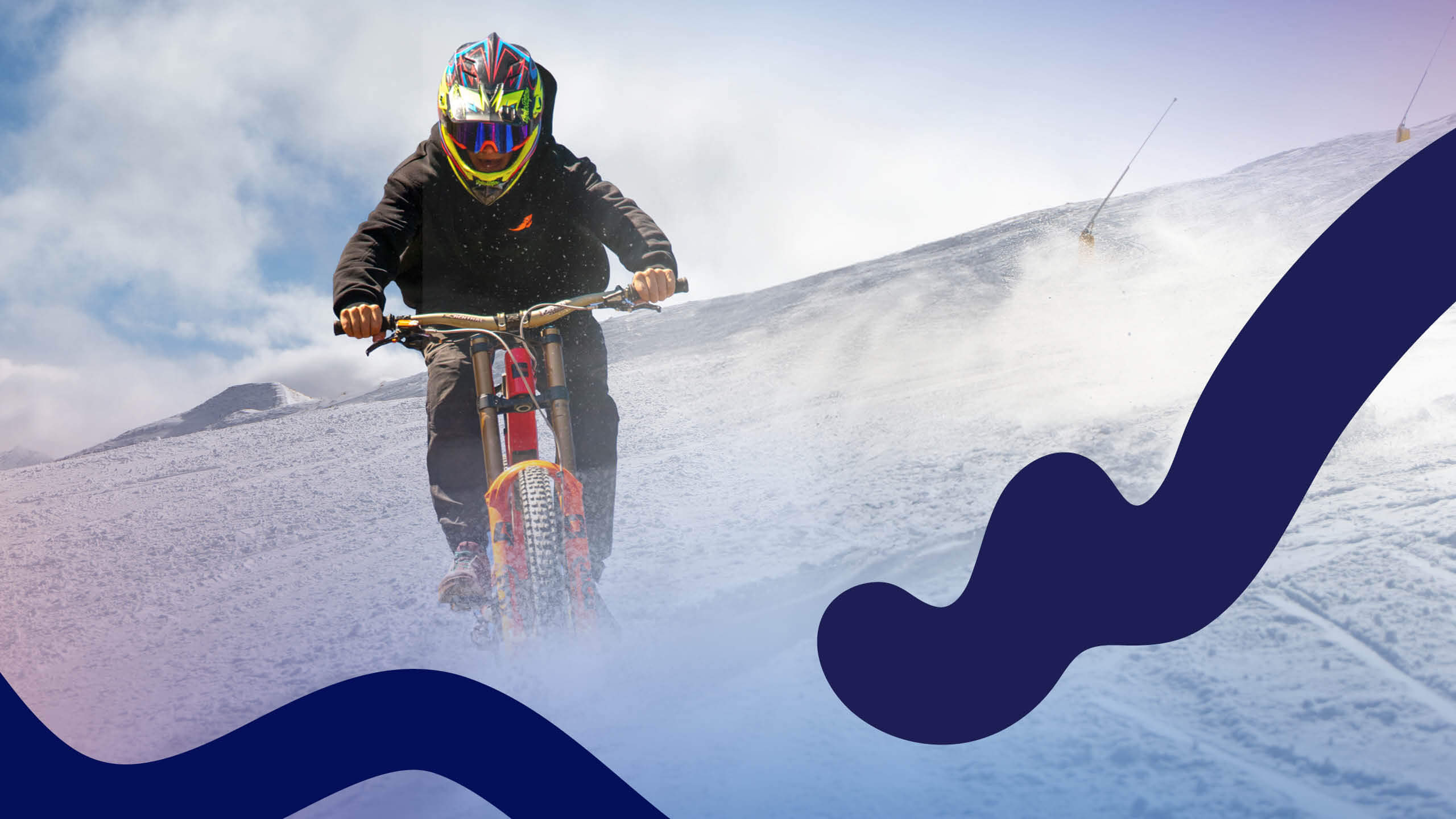 Person biking downhill on snow.