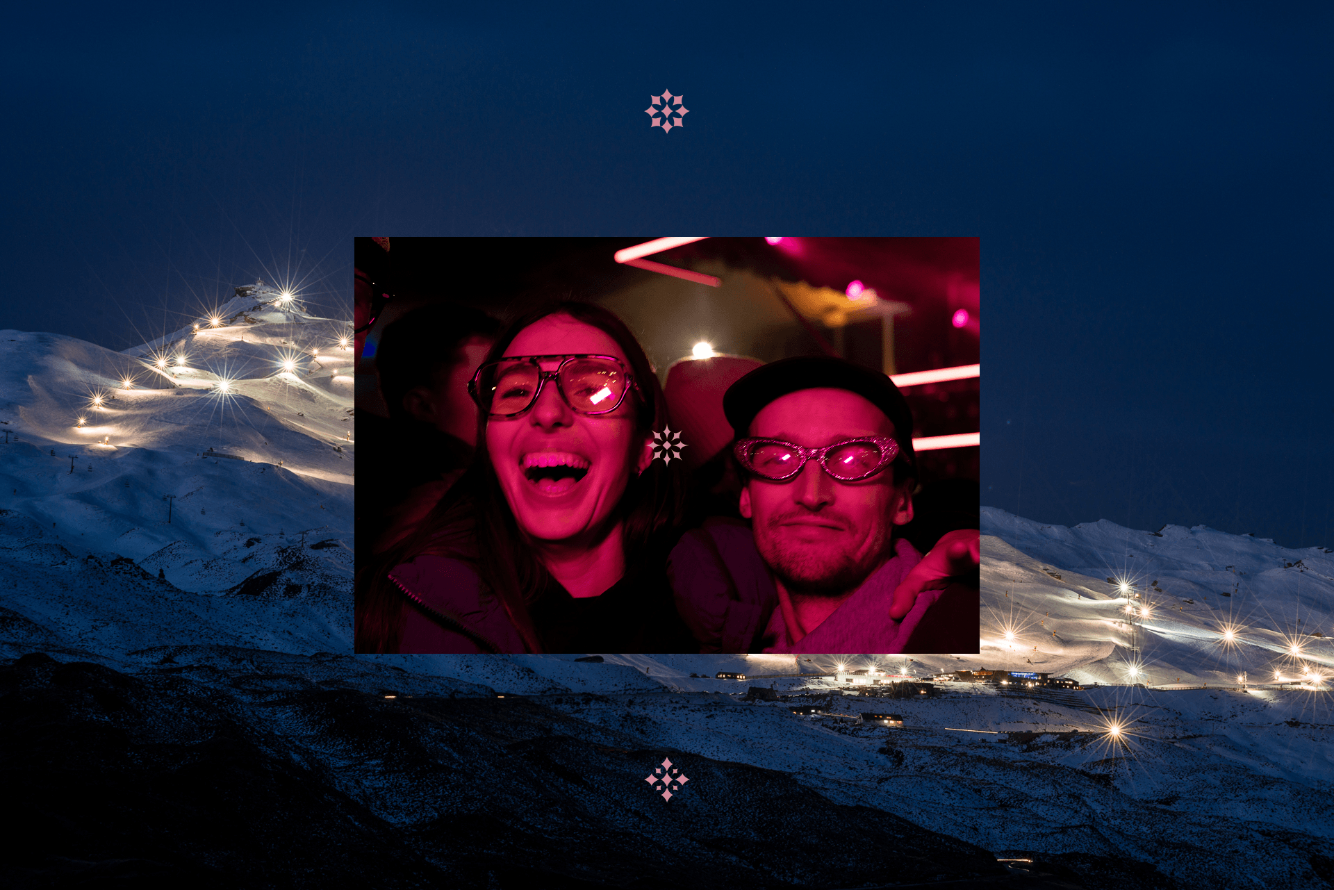 Two people wearing funky glasses smiling in a dimly lit, pink neon environment.